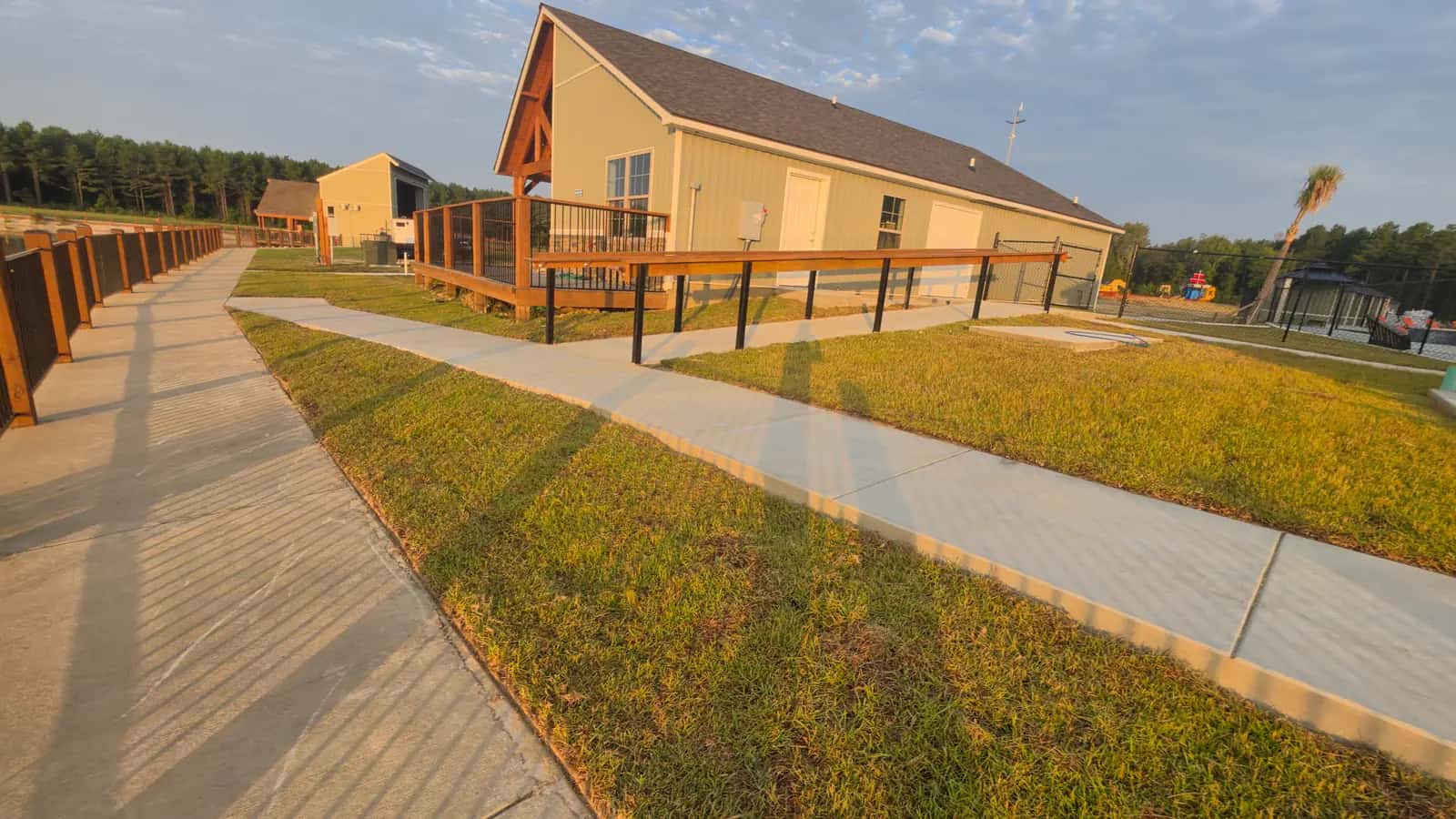 Freshly mowed commercial lawn along the boardwalk and sidewalk by the amphitheater at an RV resort in Satsuma, LA.