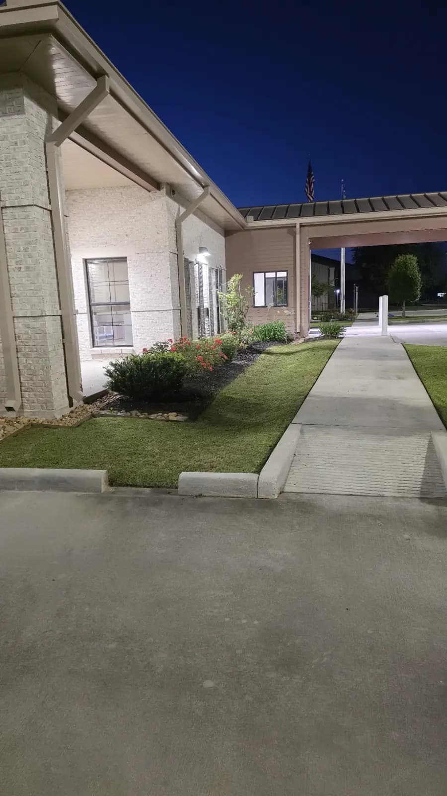 Outdoor landscape lighting glowing at dusk on a Louisiana property by Southern Buck Lawn