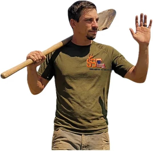 Michael Dantone, owner of Southern Buck Lawn, in a branded shirt with a shovel